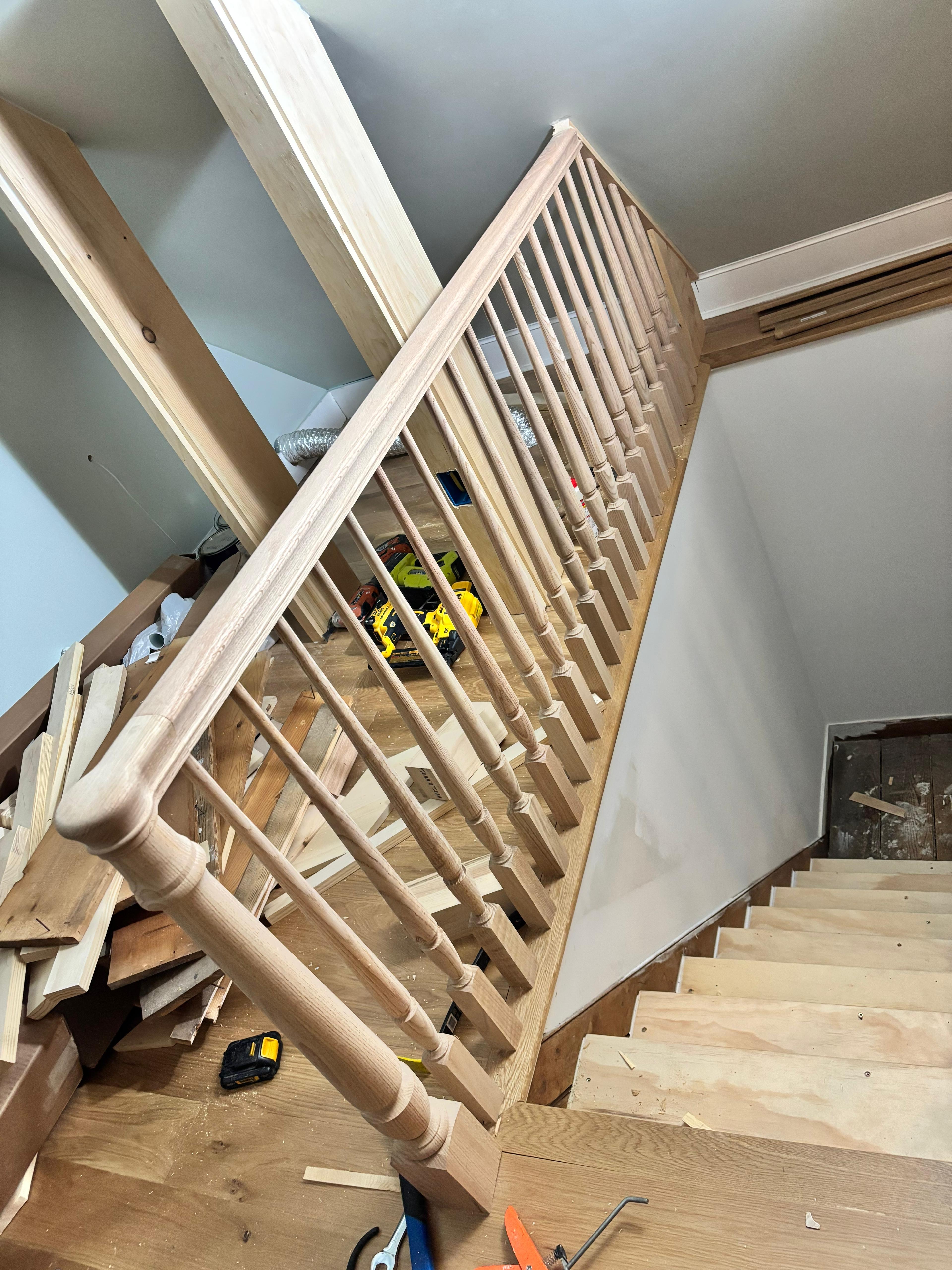 Custom oak staircase with turned balusters built by Batula Builders